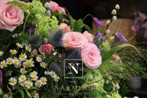 Basket of pink seasonal flowers by Narmino