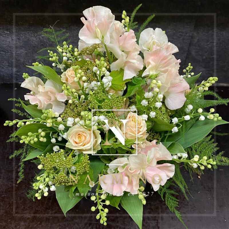 Bouquet made up of sprigs of lily of the valley and pink sweet peas