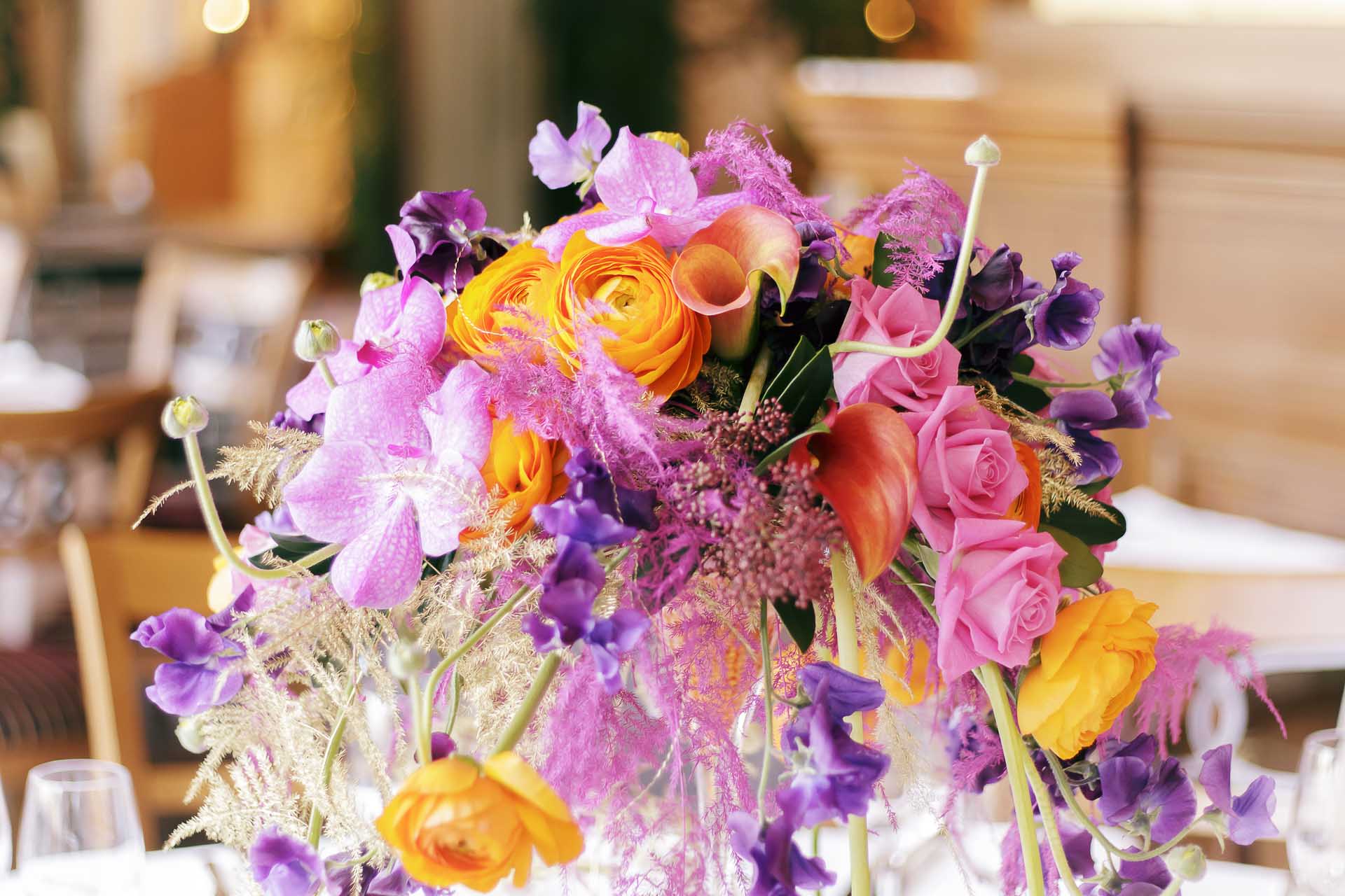 A tall, modern floral centerpiece to decorate restaurant tables in Monaco for an event, by florist Narmino. A tall, modern floral centerpiece to decorate restaurant tables in Monaco for an event, by florist Narmino.