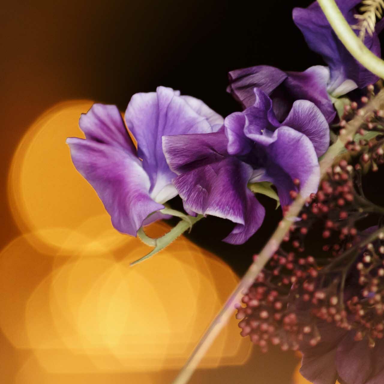 A tall, modern floral centerpiece to decorate restaurant tables in Monaco for an event, created by florist Narmino.